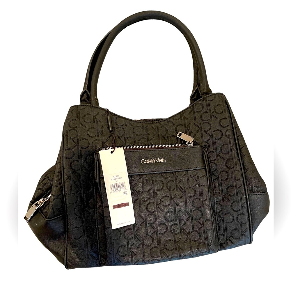 Calvin Klein Multiple interior compartments shoulder bag designed in leather.